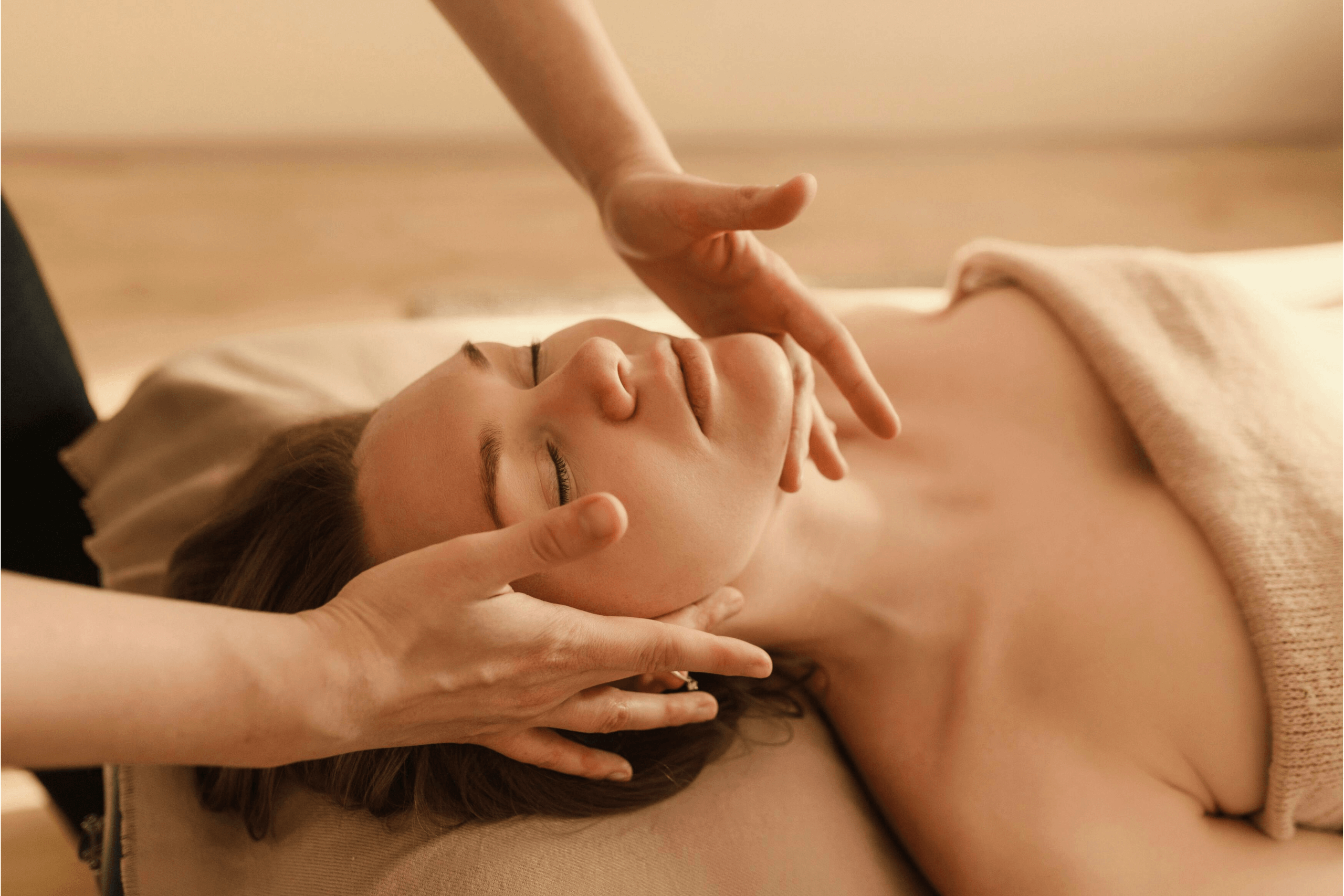 A woman receiving a rejuvenating facial massage.
