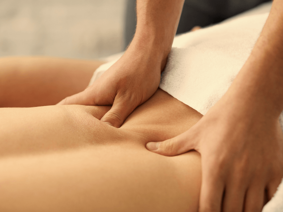 Close-up of massage therapist hands deeply massaging a client's back in Palm Harbor.